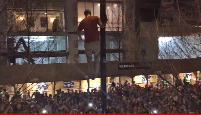 Wisconsin Badgers -- Crazy Fan Jumps Off Streetlight ... In Post Game Madness