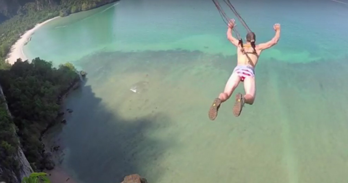 Extreme Cliff Diver -- Parachute Hooked To Back Piercing (Graphic Video)