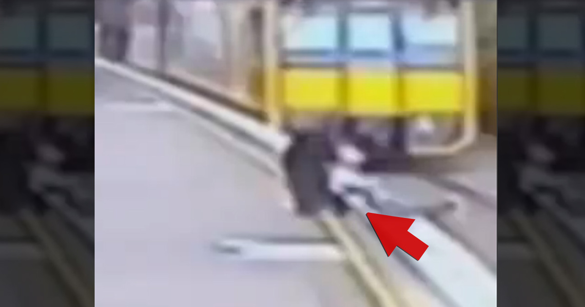 Near Disaster -- Lady Pulls Kid Off Tracks Before Train Hits (Video)