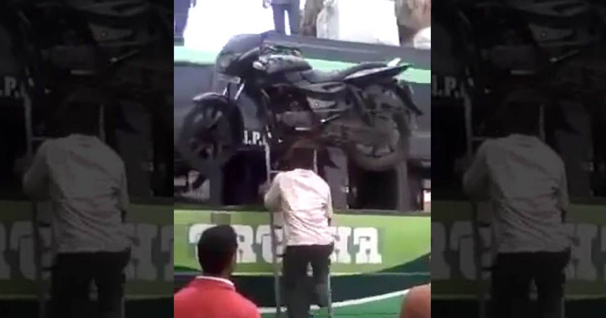 INSANE Video of a Man Balancing a Motorcycle on His Head Up a Ladder