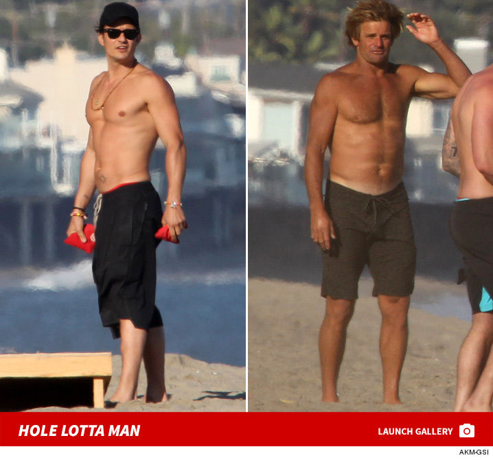 0707_orlando_bloom_laird_hamilton_shirtless_beach_launch